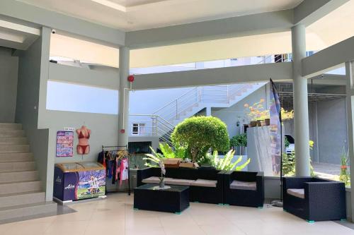 a lobby with plants and a staircase in a building at Azahar Resort Panglao powered by Cocotel in Panglao