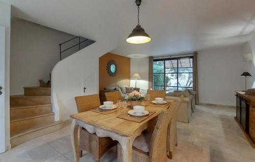 a dining room with a wooden table and chairs at Cozy Home In Saint-Laurent-De-La-Ca With Wifi in Saint-Laurent-de-la-Cabrerisse