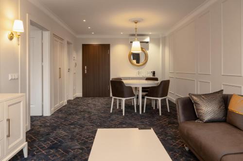 a living room with a couch and a table at Gradiali Wellness and SPA in Palanga