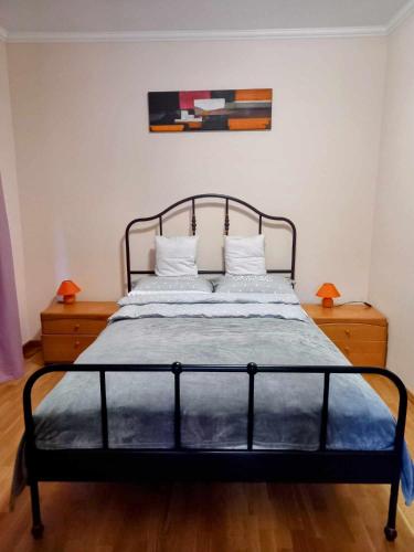 a bedroom with a bed with a metal bed frame at Bike&Night in Baracska