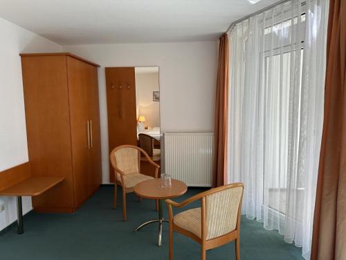 a room with a table and chairs and a window at Stoertebeker-2 in Prerow