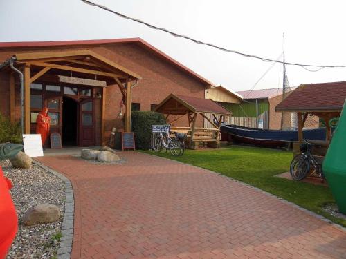un edificio con una pasarela de ladrillos frente a una casa en Urlaub beim Reriker Ostseefischer, en Rerik