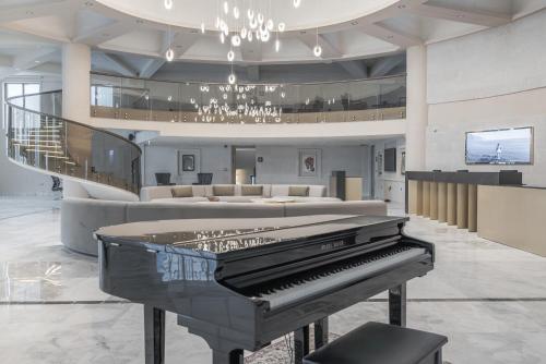 a piano in a lobby with a living room at Barceló Cappadocia in Nevsehir