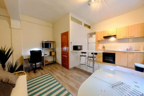 Il comprend un grand salon avec une cuisine et une table. dans l'établissement Rouen Saint Romain - Chez Solange, à Rouen