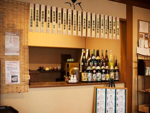 a bunch of bottles of wine sitting on a bar at Yunokura Tsuruya in Makago