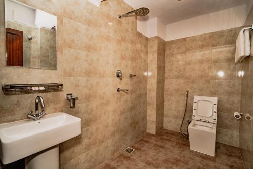 a bathroom with a sink and a toilet at Rest Up Kathmandu Hostel in Kathmandu