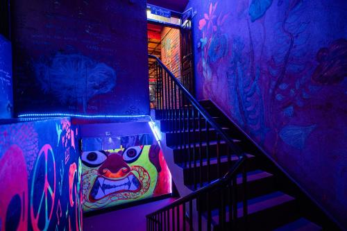 a set of stairs with a colorful painting on the wall at Rest Up Kathmandu Hostel in Kathmandu