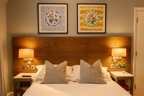 a bedroom with a large white bed with two lamps at The Georgian, Haslemere, Surrey in Haslemere