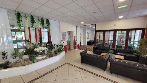 a lobby with couches and potted plants at Heathlands Hotel in Bournemouth