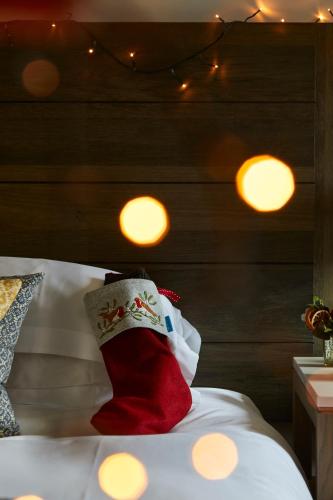 a bed with a christmas stocking on top of it at The Georgian, Haslemere, Surrey in Haslemere