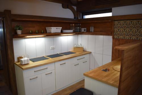 a kitchen with white cabinets and a wooden counter top at Hotel Post mit Klimaanlage in Neckarsulm