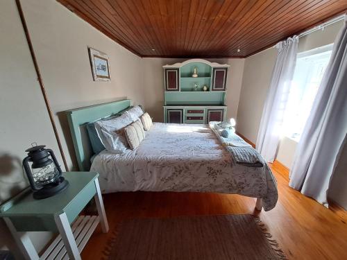 a bedroom with a bed and a table and a window at Helpmekaar Farm in Kareedouw