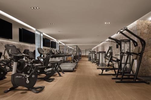 a gym with rows of treadmills and exercise bikes at The Bodrum EDITION in Yalıkavak