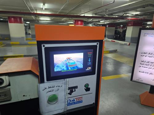 a ticket machine in a parking garage with a sign at LUXURY HOTEL APARTMENT at GRAND PLAZA SAN STEFANO, PRIME LOCATION with access to MEGA MALL and FOUR SEASONS'S RESTAURANTS in Alexandria