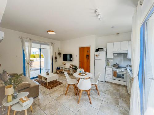 a kitchen and living room with a table and chairs at Diana HATS 1B, Pool, Paphos Center in Paphos City