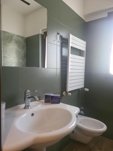 a bathroom with a white sink and a mirror at La Locanda di Castromediano - Al Becco della Civetta in Castelmezzano