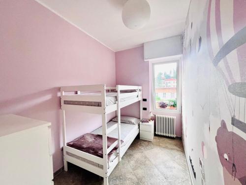 a small room with a bunk bed and a window at I piedi nell'acqua in Finale Ligure