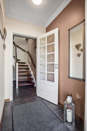 a hallway with a door leading to a stairway at ARCTIC HOMES - Villa Borealis in Tromsø