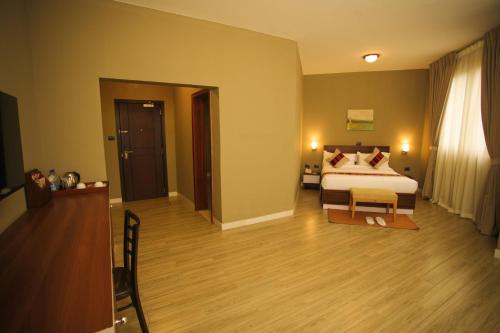 a hotel room with a bed and a room at Haile Hotel Wolaita in Sodo