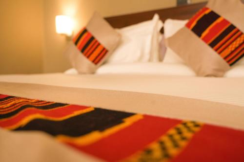 a close up of a bed in a hotel room at Haile Hotel Wolaita in Sodo