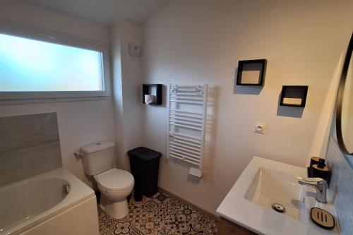 a bathroom with a toilet and a tub and a sink at A l'ombre du chêne Piscine & Spa Gîtes Eden en Cévennes à Anduze Gard in Anduze