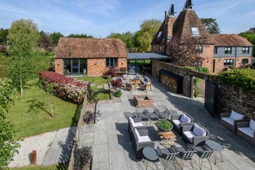 an overhead view of a patio with chairs and tables at Vineyard Oast Sleeps 25 in Wavehorne