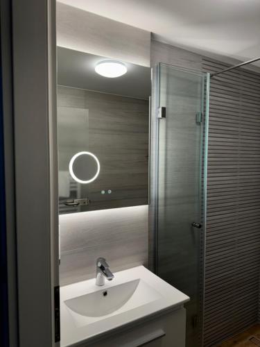 a bathroom with a sink and a mirror at Waldhotel Wandlitz in Wandlitz