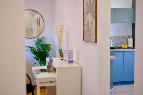 a white desk with a laptop on it in a kitchen at Rouen - Bienvenue chez Alice in Rouen