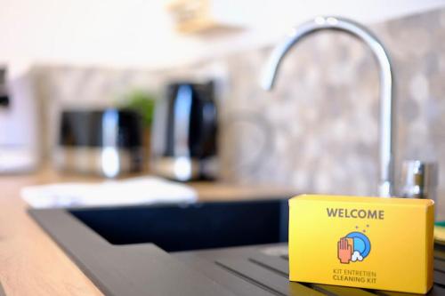 a yellow mug sitting on a counter next to a sink at Rouen - Bienvenue chez Alice in Rouen