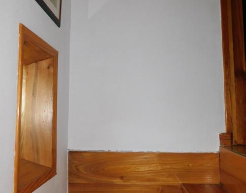 a room with a white wall and a wooden door at La Casa De Luis in Castiello de Jaca