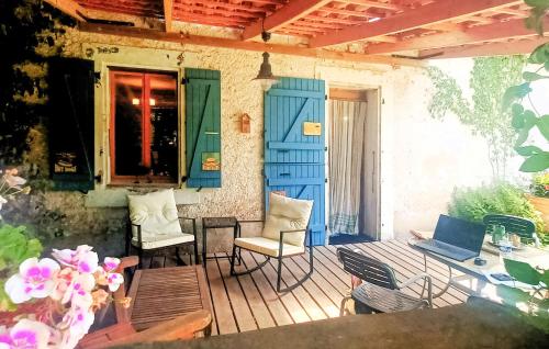 a porch with chairs and a table with a laptop on it at Nice Home In Marsanne in Marsanne