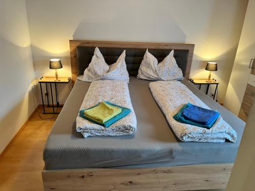 a bedroom with a bed with two pillows on it at Sunside Apartments in Bad Mitterndorf
