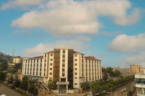 a large white building in front of a street at Haile Hotel Wolaita in Sodo