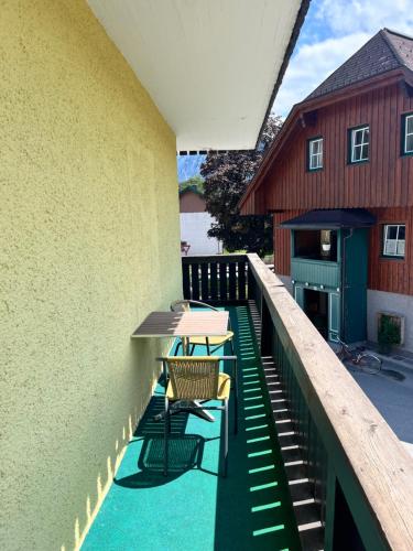 a balcony with two tables and chairs on a building at Sunside Apartments in Bad Mitterndorf