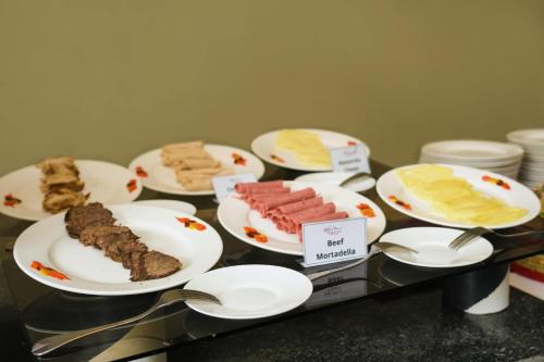 a bunch of plates of food on a table at Haile Hotel Wolaita in Sodo
