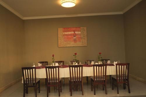 a dining room with a long table and chairs at Haile Hotel Wolaita in Sodo