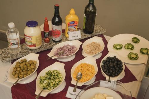 a table with plates of food and bottles of alcohol at Haile Hotel Wolaita in Sodo