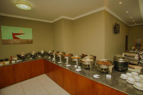 a kitchen with many pots and pans on a counter at Haile Hotel Wolaita in Sodo