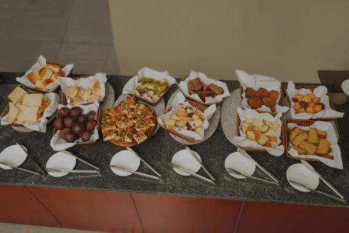 a bunch of different types of food on a counter at Haile Hotel Wolaita in Sodo