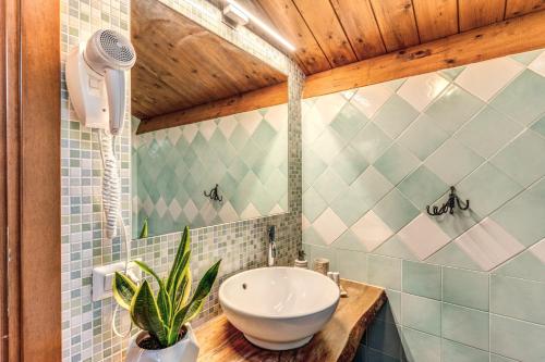 a bathroom with a sink and a hair dryer at Casale Giancesare Villa Agricola in Capaccio-Paestum