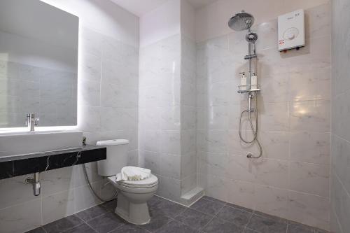 a bathroom with a shower and a toilet and a sink at Nariya Bayfront Phuket in Ban Bang Chak