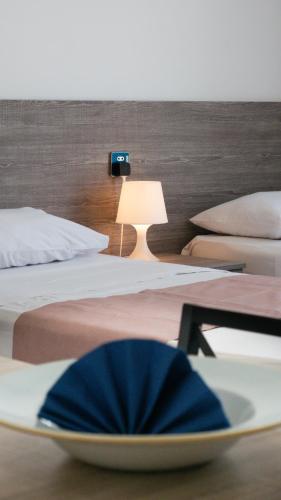 a bowl on a table in a room with two beds at For Rest Aparthotel in St Paul's Bay