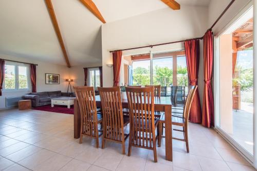 a dining room with a table and chairs at Villa Agape in Sampzon