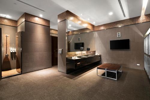 a bathroom with a sink and a mirror at Grande Centre Point Hotel Ratchadamri Bangkok in Bangkok