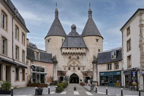 a large building with two towers on a street at La bulle urbaine in Nancy