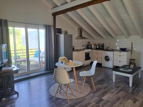 a kitchen with a table and chairs in a room at Studio ISABEL in Sálakos