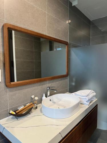 a bathroom with a sink and a mirror at Alala Homestay- Tuyen Quang City Center- Trung tâm thành phố Tuyên Quang in Tuyên Quang