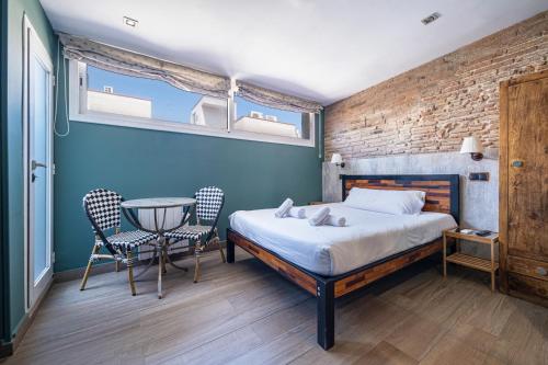 En eller flere senge i et værelse på AinB Born-Dames Apartments