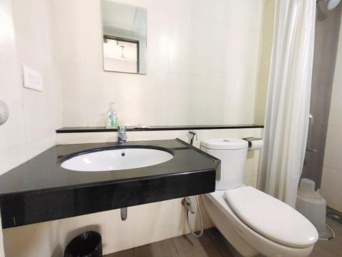 a bathroom with a sink and a toilet at Private Rooms In Blue Ridge in Hinjewadi
