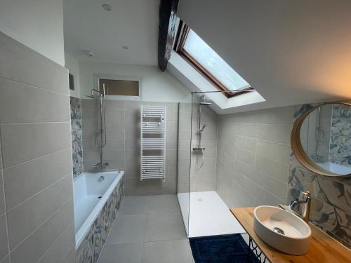 a bathroom with a sink and a tub and a shower at La Callibetière in Tourtoirac